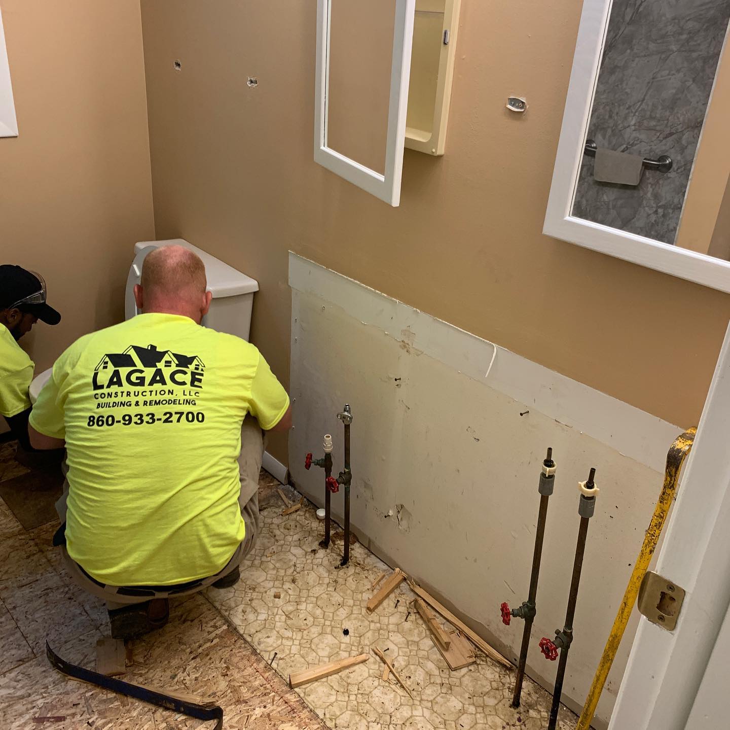 Lagace Construction crew performing bathroom remodel in Tolland County CT, preparing plumbing and fixture installation.